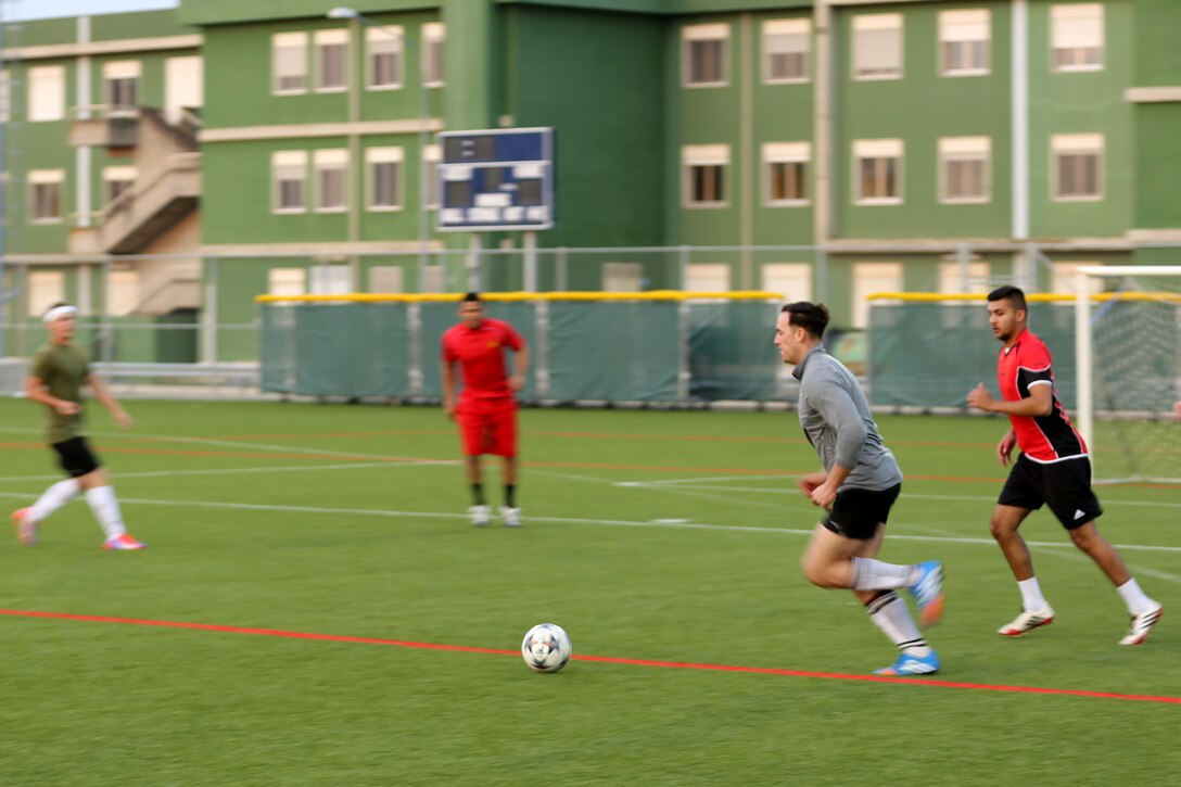 Corporal Joshua Braun, a ground radio technician with Special-Purpose Marine Air-Ground Task Force Africa 14, plays a soccer game aboard Naval Air Station Sigonella, Italy, April 15, 2014. He says he joined the Marine Corps because he “knew looking back on my life the one regret I would have would be to not serve in the military and I don’t like to live life with regrets. I wanted to serve my country and I wanted to be a positive influence on the men I served with.”