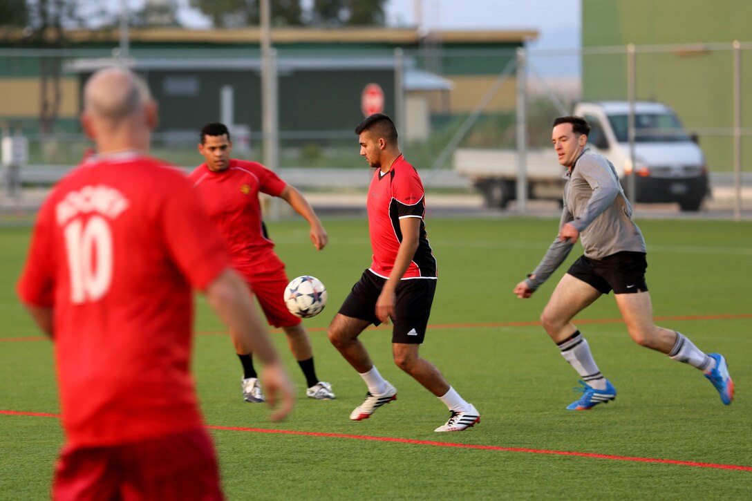 Corporal Joshua Braun (grey shirt), a ground radio technician with Special-Purpose Marine Air-Ground Task Force Africa 14, plays a soccer game aboard Naval Air Station Sigonella, Italy, April 15, 2014. He says he joined the Marine Corps because he “knew looking back on my life the one regret I would have would be to not serve in the military and I don’t like to live life with regrets. I wanted to serve my country and I wanted to be a positive influence on the men I served with.”