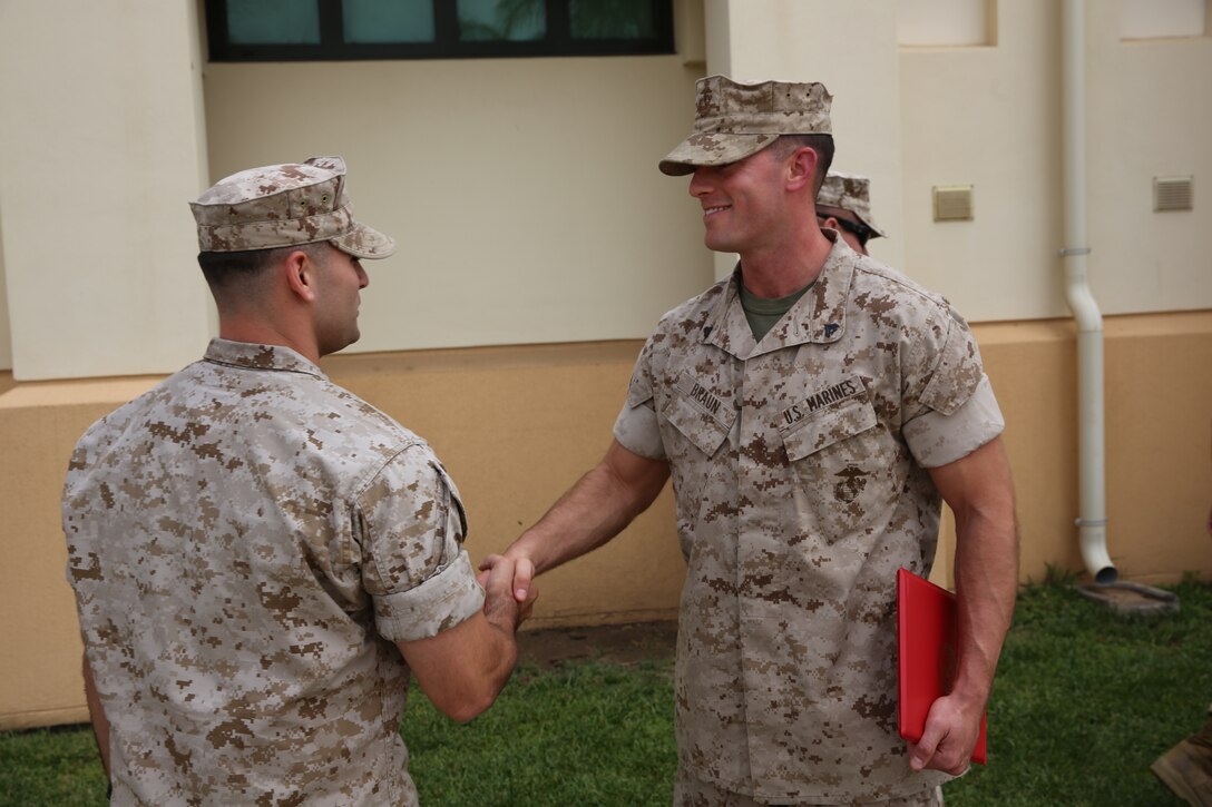 Corporal Joshua Braun (right), a ground radio technician with Special-Purpose Marine Air-Ground Task Force Africa 14, is congratulated by his officer in charge, 1st Lt. Robert Lane, after Braun’s promotion ceremony, June 2, 2014. Braun was meritoriously promoted to his present rank.