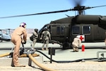 Marines at Twenty Nine Palms refuel a New Mexico National Guard helicopter during joint training. 