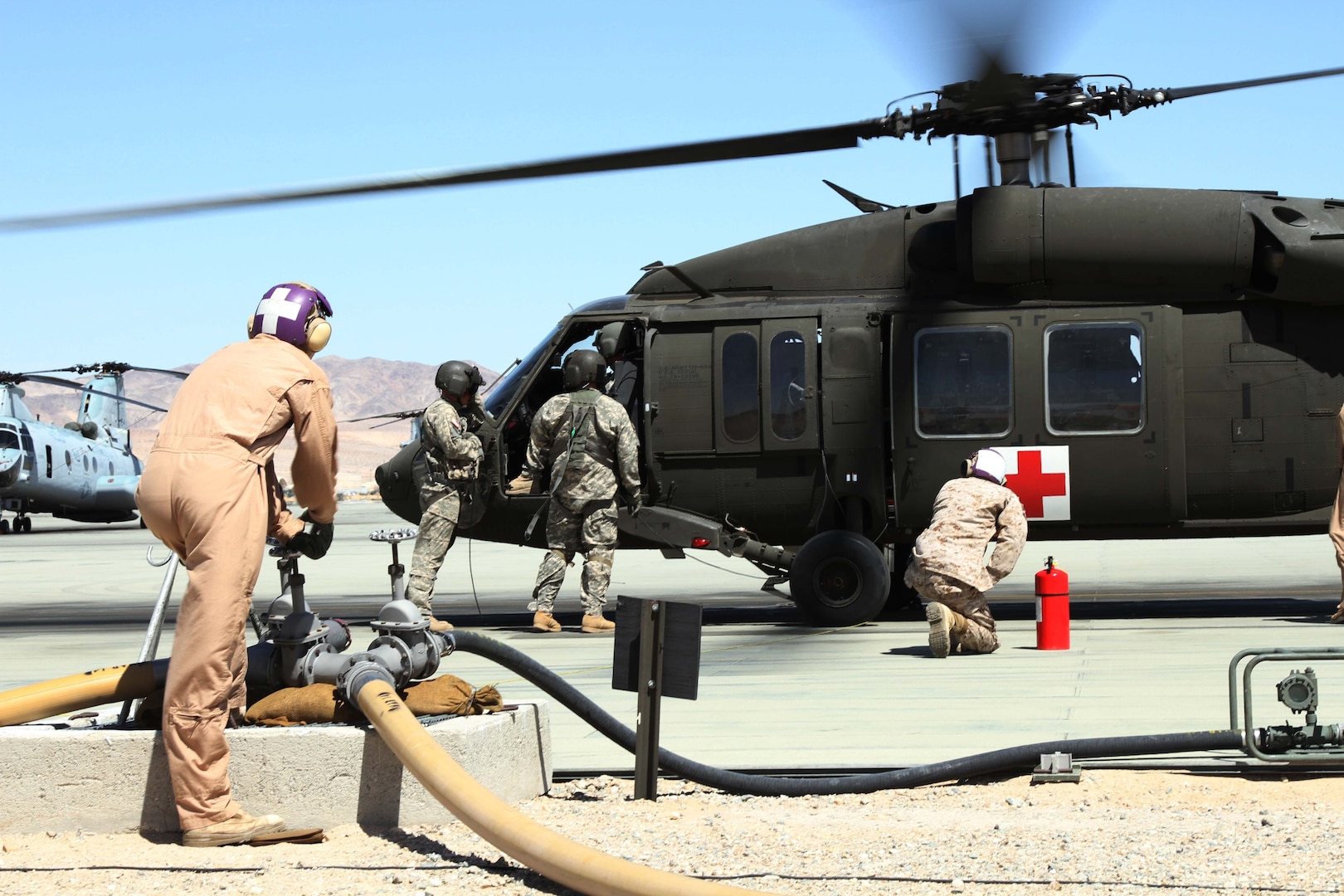 Marines at Twenty Nine Palms refuel a New Mexico National Guard helicopter during joint training. 