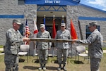 Florida Air National Guard State Command Chief Master Sgt. Robert Lee (left) and Senior Master Sgt. Cory Brown (right) unveil the new official colors for the 131st Training Flight at Camp Blanding Joint Training Center, April 12, 2012. The Florida Air National Guard's Weather Readiness Training Center was deactivated and replaced as the 131st Training Flight was activated.