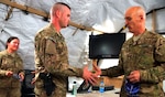 Army Command Sgt. Richard J. Burch, the Army National Guard command sergeant major, awards a coin for outstanding performance to Army Spc. Jonathon Richards during a visit with the Kentucky National Guard's Agribusiness Development Team 4 on April 4, 2012 in southern Afghanistan.