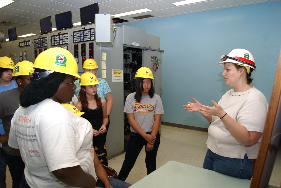 Sarah Cary, a mechanical engineer currently on a developmental assignment to the powerhouse at Keystone Dam, gives a tour of the control room to students in the Tulsa Alliance for Engineering summer camp. Cary and explained the process by which hydroelectric dams create clean electricity.