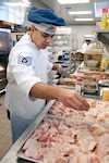 Air Force Tech. Sgt. Santos Flores, of the 162nd Force Support Squadron at Tucson International Airport, adds a little "zing" to sheet pans of chicken pieces during the unit's training weekend Feb. 11, 2012. Flores and his fellow foodservice Airmen at the 162nd Fighter Wing captured the 2012 Senior Master Sgt. Kenneth W. Disney Award, and will be traveling to Chicago to receive their honors in May.