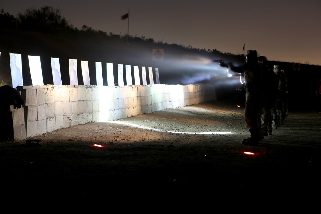 Marines and police officers with the Marine Corps Air Station Miramar Provost Marshal’s Office conduct a live-fire training exercise in low-light conditions aboard MCAS Miramar, Calif., June 18. The Marines and police officers also conducted a practical weapons course as part of the annual training requirements.