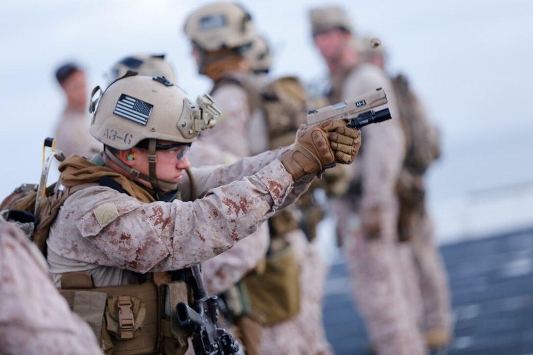 A Marine with the Force Reconnaissance Detachment, 11th Marine Expeditionary Unit, sights in on his target with a Marine Corps Close Quarters Battle pistol during a close quarters tactics range on the flight deck of the USS San Diego as part of Certification Exercise (CERTEX), off the coast of Southern California, June 19, 2014. CERTEX is the final evaluation of the 11th MEU and Makin Island Amphibious Ready Group prior to deployment. The evaluation requires the Marines and sailors to plan and conduct integrated missions simulated to reflect real-world operations. (U.S. Marine Corps photo by Cpl. Jonathan R. Waldman/RELEASED)