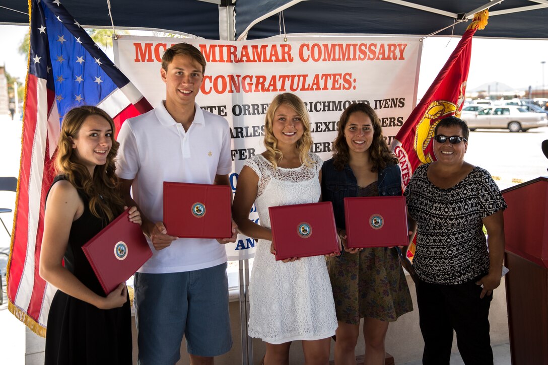 Scholarship winners pose for a photo with Lisa Martinez, scholarship sponsor, at the Defense Commissary Agency and the Fisher House Foundation Scholarship award ceremony aboard Marine Corps Air Station Miramar, Calif., June 19. The winners wrote essays about the difficulties military families face for the scholarship.  