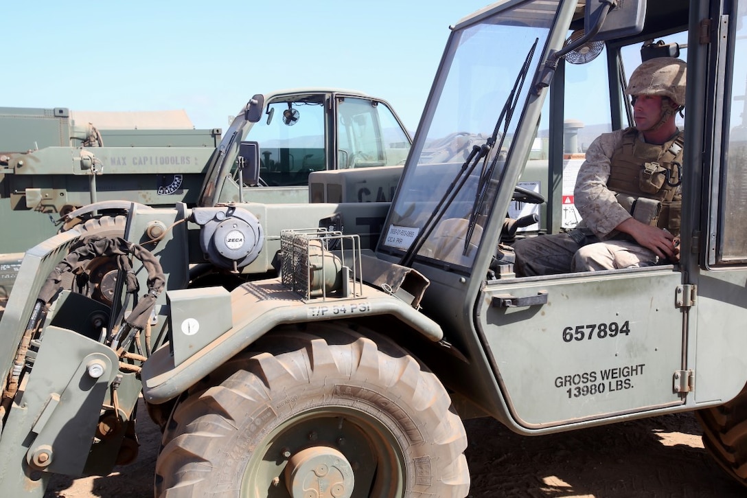 Lance Cpl. Francis Trezza, a heavy equipment operator with 9th Communication Battalion, I Marine Expeditionary Force, prepares to operate a forklift during the 2014 I Marine Expeditionary Brigade command post exercise aboard Camp Pendleton, Calif., June 19, 2014. The CPX was designed to help improve the 1st Marine Expeditionary Brigade's readiness for deployment. (U.S. Marine Corps photo by Lance Cpl. David Silvano/released)