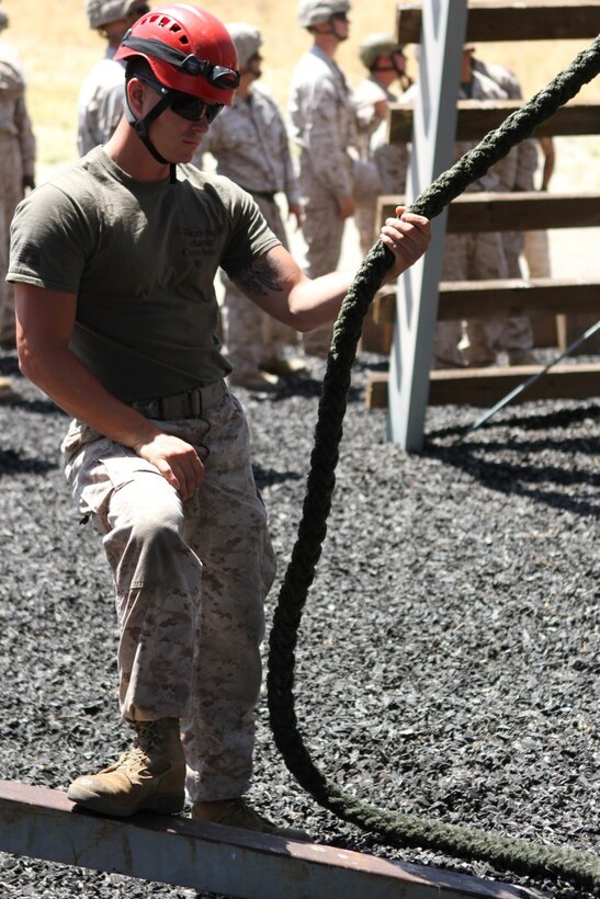 Sergeant Adam Powell, from Newark, Calif., Helicopter Rope Suspension Technique Course chief instructor, Special Operations Training Group, waits for Marines to begin training at the HRST course aboard Camp Pendleton, Calif., June 16, 2014. This was a 13-day course which began June 11, where the Marines learned how to tie knots, and fast rope and rappel from towers and helicopters. (U.S. Marine Corps photo by Lance Cpl. Tony Simmons)