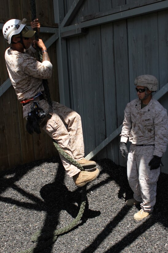 Marines with 2nd Battalion, 4th Marine Regiment and 2nd Battalion, 7th Marine Regiment, are instructed on fast-roping during the Helicopter Rope Suspension Techniques course aboard Camp Pendleton, Calif., June 16, 2014. This was a 13-day course which began June 11, where the Marines learned how to tie knots, and fast rope and rappel from towers and helicopters. (U.S. Marine Corps photo by Lance Cpl. Tony Simmons)