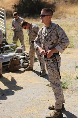 Marines with 2nd Battalion, 4th Marine Regiment and 2nd Battalion, 7th Marine Regiment, prepare their harnesses during the Helicopter Rope Suspension Techniques course aboard Camp Pendleton, Calif., June 16, 2014. This was a 13-day course which began June 11, where the Marines learned how to tie knots, and fast rope and rappel from towers and helicopters. (U.S. Marine Corps photo by Lance Cpl. Tony Simmons)