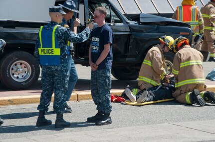 A U.S. sailor gives a simulated breathalyzer test during a simulated drunk-driving accident during a Keep What You've Earned fair at Naval Base Kitsap Bangor, July 16, 2013, in Silverdale, Wash. 