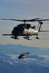 Two HH-60 Pave Hawk helicopters from the Alaska Air National Guard fly over Alaska during a training mission Feb. 18, 2011.
