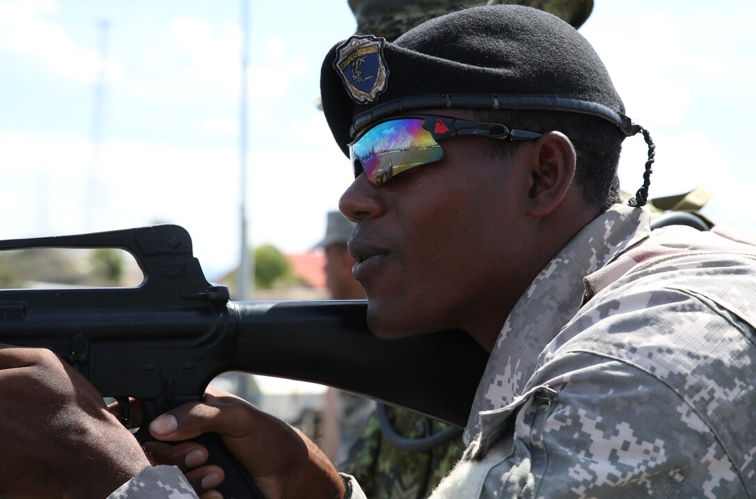 Pfc. Mateo Fernandez of the Dominican Republic Armed Forces shouts commands as he simulates clearing a room during Exercise Tradewinds 2014 at Las Calderas Naval Base, June 19, 2014. Tradewinds 2014 is a joint, combined exercise conducted in order to build partner nation counter-transnational organized crime missions, humanitarian aid and disaster response operations capacity. The ultimate goal of Tradewinds 2014 is to promote interoperability and multinational relationships throughout the Caribbean theater. 