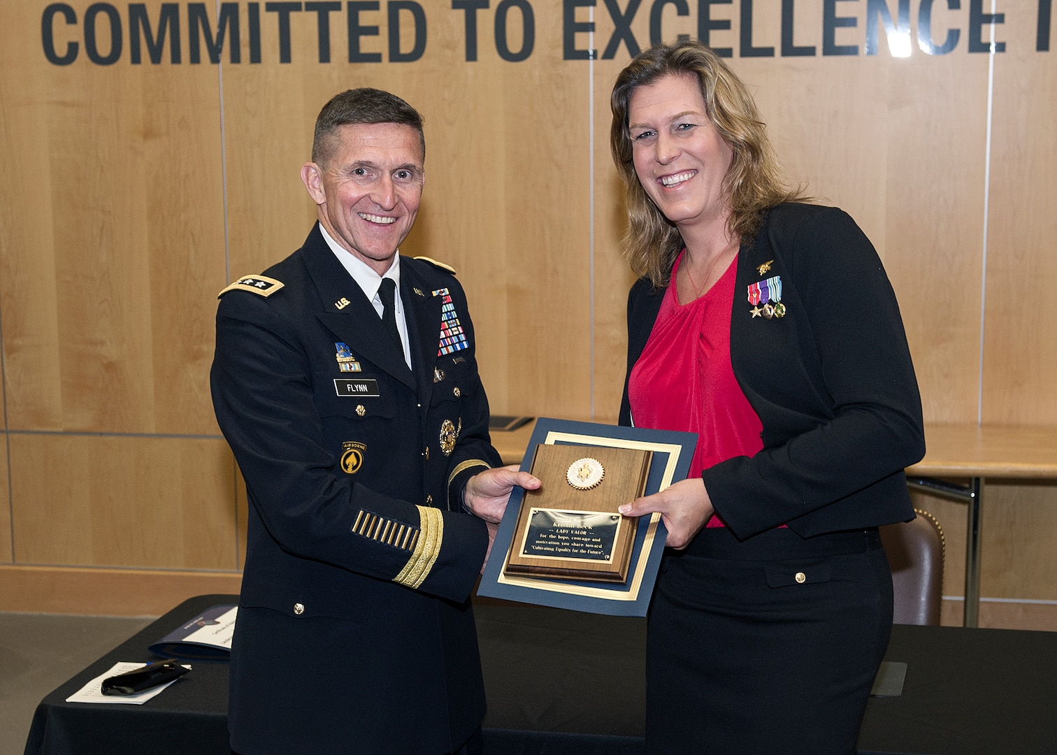 Retired Navy SEAL Kristin Beck receives a plaque from DIA Director Lt. Gen. Michael Flynn following the agency’s Pride Month event June 18. 