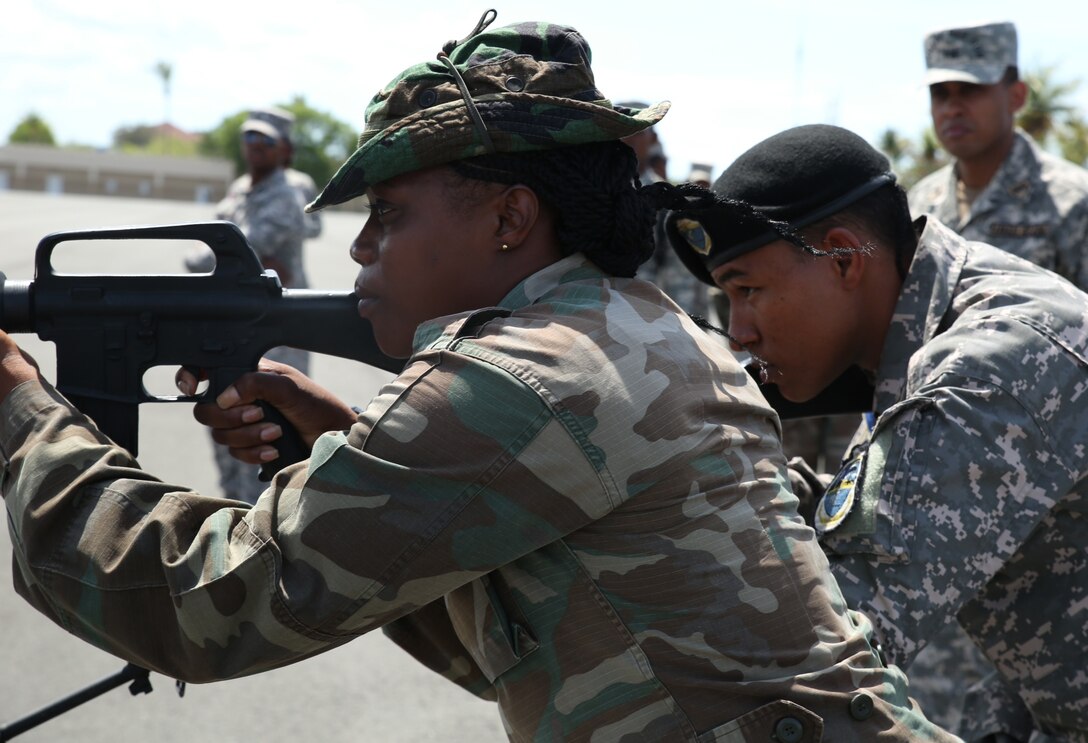 Lance Cpl. Ikesha Thomas, Antigua and Barbudan Defense Force, and Sgt. Yeuris Aponte, Dominican Republic Armed Forces, simulate clearing rooms during Exercise Tradewinds 2014 at Las Calderas Naval Base, June 19, 2014. Tradewinds 2014 is a joint, combined exercise conducted in order to build partner nation counter-transnational organized crime missions, humanitarian aid and disaster response operations capacity. The ultimate goal of Tradewinds 2014 is to promote interoperability and multinational relationships throughout the Caribbean theater. 