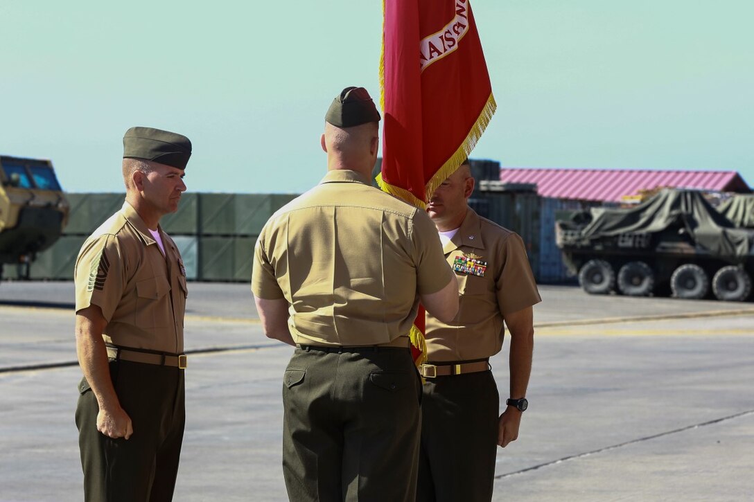 Lieutenant Col. Gilbert D. Juarez (right), past commanding officer for 1st Light Armored Reconnaissance Battalion, 1st Marine Division, I Marine Expeditionary Force, passes the organizational colors to Lt. Col. Christian M. Rankin (left), present commanding officer for 1st LAR, 1st Marine Division, I MEF during a change of command ceremony aboard Camp Pendleton, Calif., June 19, 2014. Juarez served as the commanding officer for two years. (U.S. Marine Corps photo by Lance Cpl. Anna Albrecht)