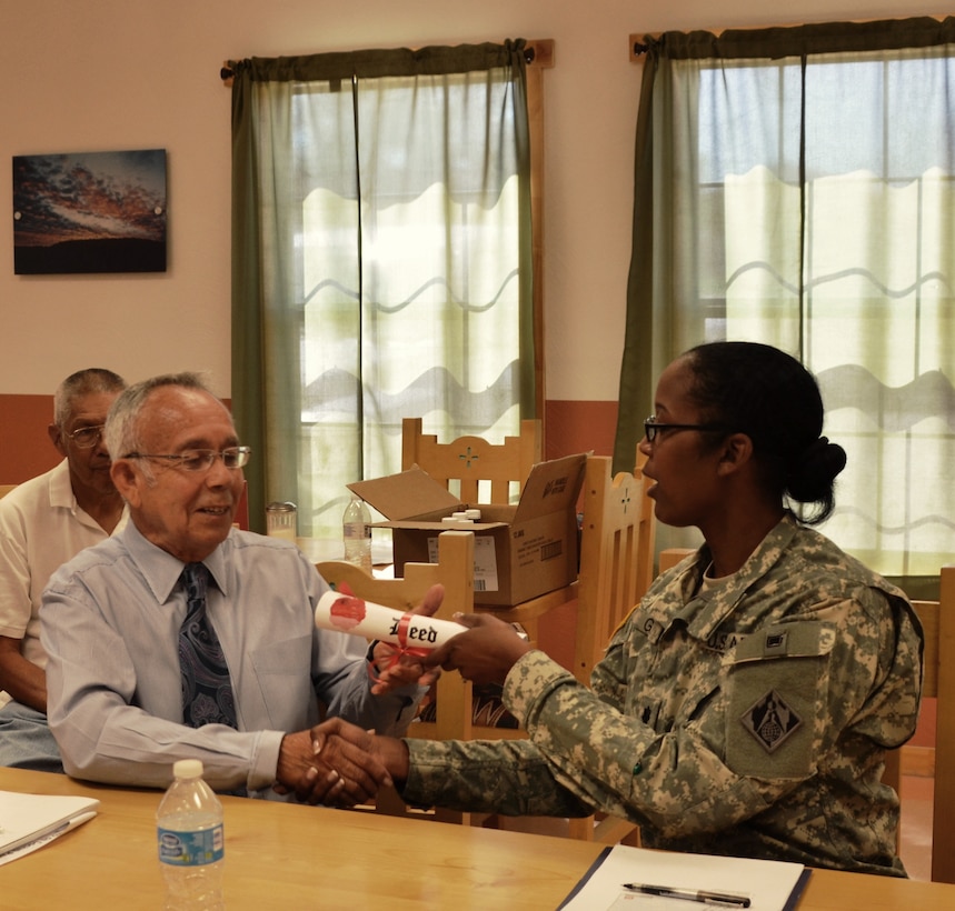 COCHITI PUEBLO, N.M., -- Albuquerque District Commander Lt. Col. Antoinette Gant relinquishes land acquired by the Corps during the construction of Cochiti Dam over 50 years ago to Cochiti Governor Joseph Suina, June 5, 2014. 

