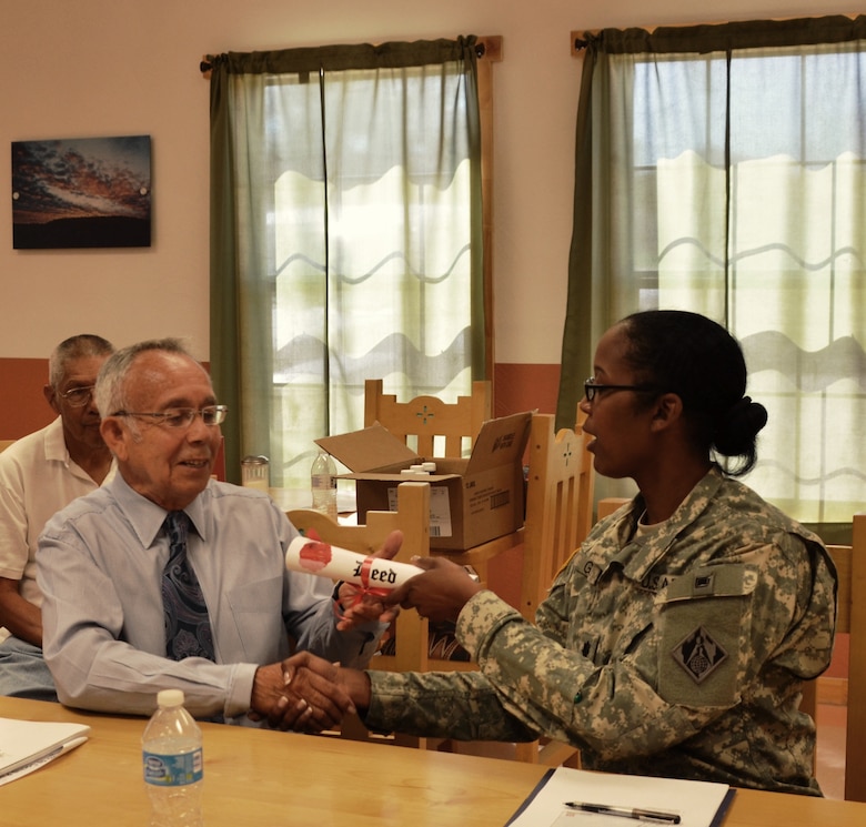 COCHITI PUEBLO, N.M., -- Albuquerque District Commander Lt. Col. Antoinette Gant relinquishes land acquired by the Corps during the construction of Cochiti Dam over 50 years ago to Cochiti Governor Joseph Suina, June 5, 2014. 

