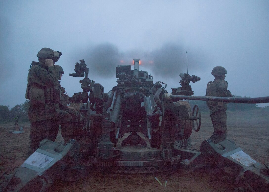 Marines fire an M777A2 lightweight 155 mm howitzer at dusk June 10 during Artillery Relocation Training Program 14-1 at the Ojojihara Maneuver Area, Japan. During the exercise, artillery Marines trained in relocating artillery positions, artillery live-fire, small-arms weapons tactics and other sustainment events. The Marines are field artillery cannoneers with Battery C, 1st Battalion, 10th Marine Regiment, currently assigned to 3rd Battalion, 12th Marines, 3rd Marine Division, III Marine Expeditionary Force, under the unit deployment program. (U.S. Marine Corps photo by Sgt. Jose O. Nava/Released)