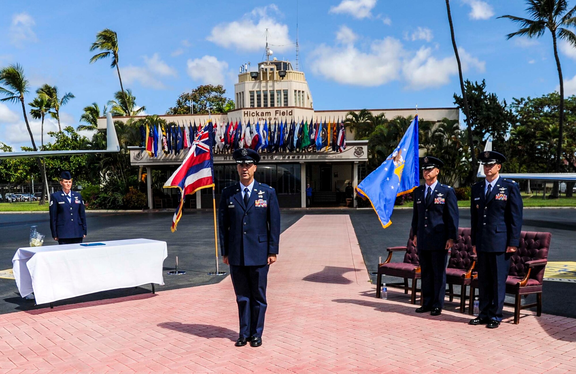 Col. Michael Merritt, 15th Operations Group commander, center, addresses the audience during the 65th Airlift Squadron change of command ceremony on the flightline at Joint Base Pearl-Harbor-Hickam, Hawaii June 20, 2014. During the ceremony Lt. Col. Benjamin Menges took command of the squadron from Lt. Col. Brian Mackey. (U.S. Air Force photo/Tech. Sgt. Terri Paden)