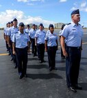 Members of the 65th Airlift Squadron stand in formation on the flightline at Joint Base Pearl Harbor-Hickam, Hawaii, during the squadron change of command ceremony June 20, 2014. During the ceremony, Lt. Col. Benjamin Menges took command of the squadron from Lt. Col. Brian Mackey. (U.S. Air Force photo/Tech. Sgt. Terri Paden)