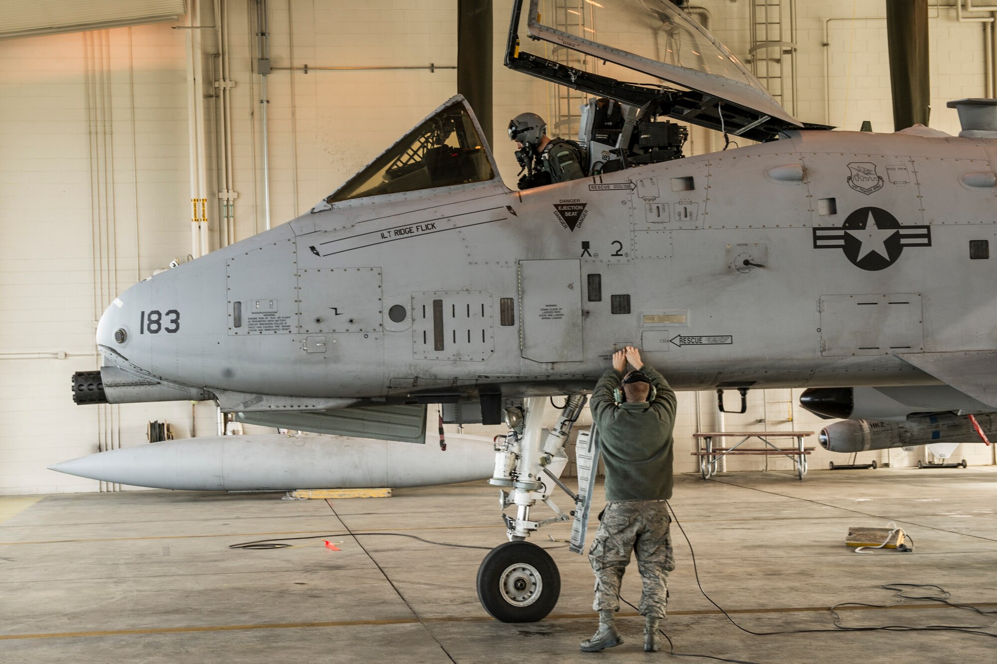 U.S. Air Force Lt. Col. Dan Walls, 25th Fighter Squadron pilot and Senior Airman Eric Brecula, 51st Aircraft Maintenance Squadron maintainer both assigned to Osan Air Base, South Korea, perform pre-flight inspections during RED FLAG-Alaska 14-2 June 20, 2014, Eielson Air Force Base, Alaska. During RF-A exercises, participants utilize the Joint Pacific Alaska Range Complex to fly combat simulations. (U.S. Air Force photo by Senior Airman Joshua Turner/Released)