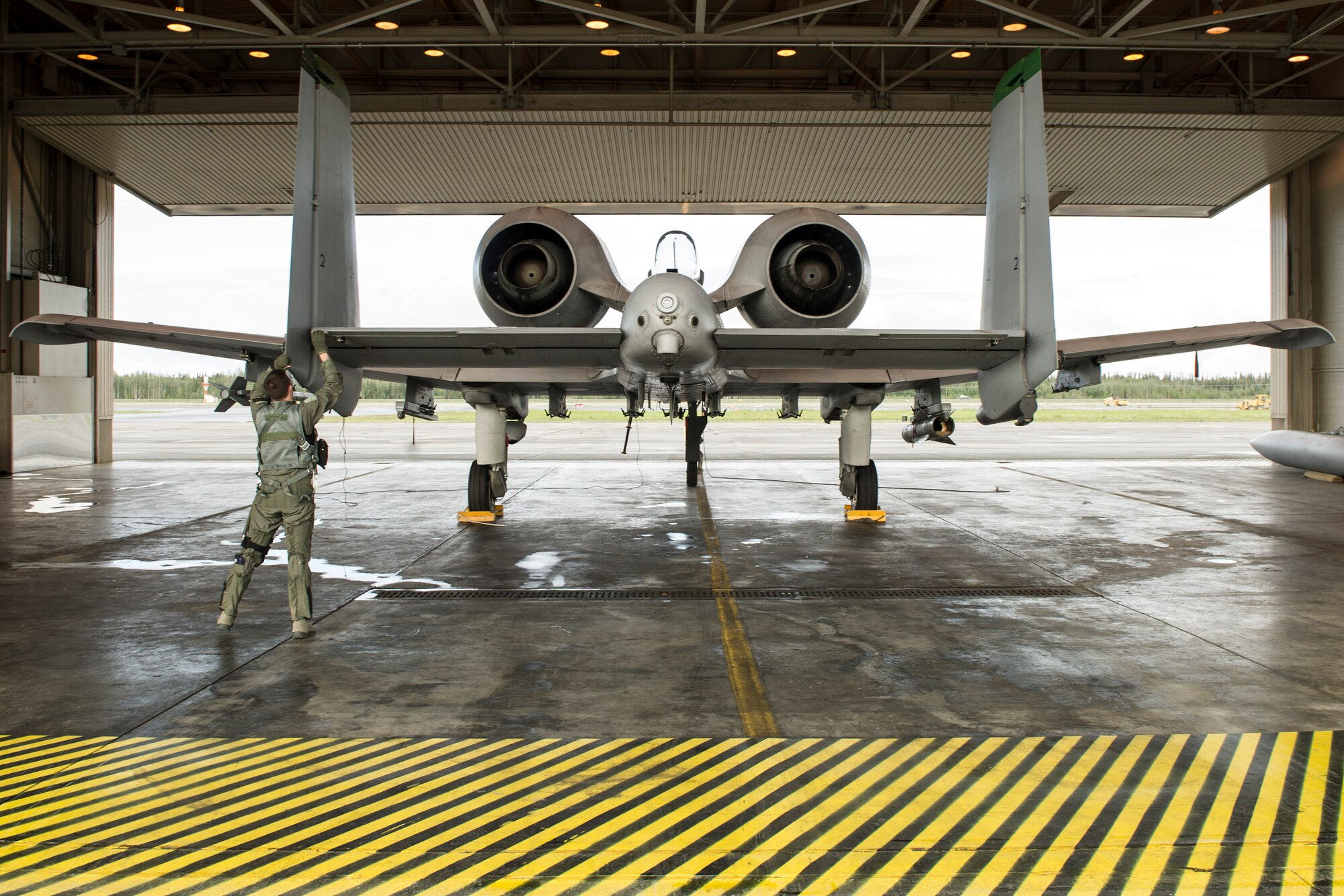 U.S. Air Force Lt. Col. Dan Walls, 25th Fighter Squadron pilot assigned to Osan Air Base, South Korea, performs pre-flight inspections during RED FLAG-Alaska 14-2 June 20, 2014, Eielson Air Force Base, Alaska. RF-A is a multinational, joint exercise enablining air crew and maintenance units to test their capabilities in a simulated deployed environment. (U.S. Air Force photo by Senior Airman Joshua Turner/Released)