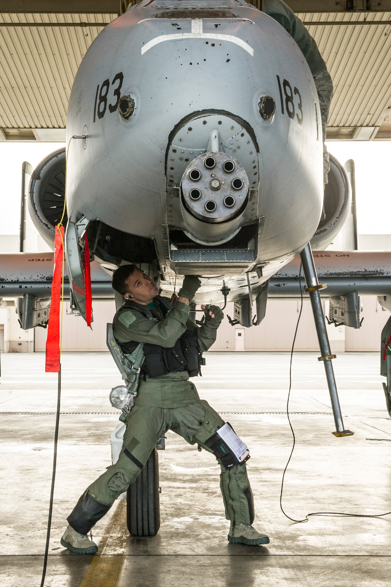 U.S. Air Force Lt. Col. Dan Walls, 25th Fighter Squadron pilot assigned to  Osan Air Base, South Korea, performs pre-flight inspections during RED FLAG-Alaska 14-2 June 20, 2014, Eielson Air Force Base, Alaska. During RF-A exercises, participants utilize the Joint Pacific Alaska Range Complex to fly combat simulations. (U.S. Air Force photo by Senior Airman Joshua Turner/Released)