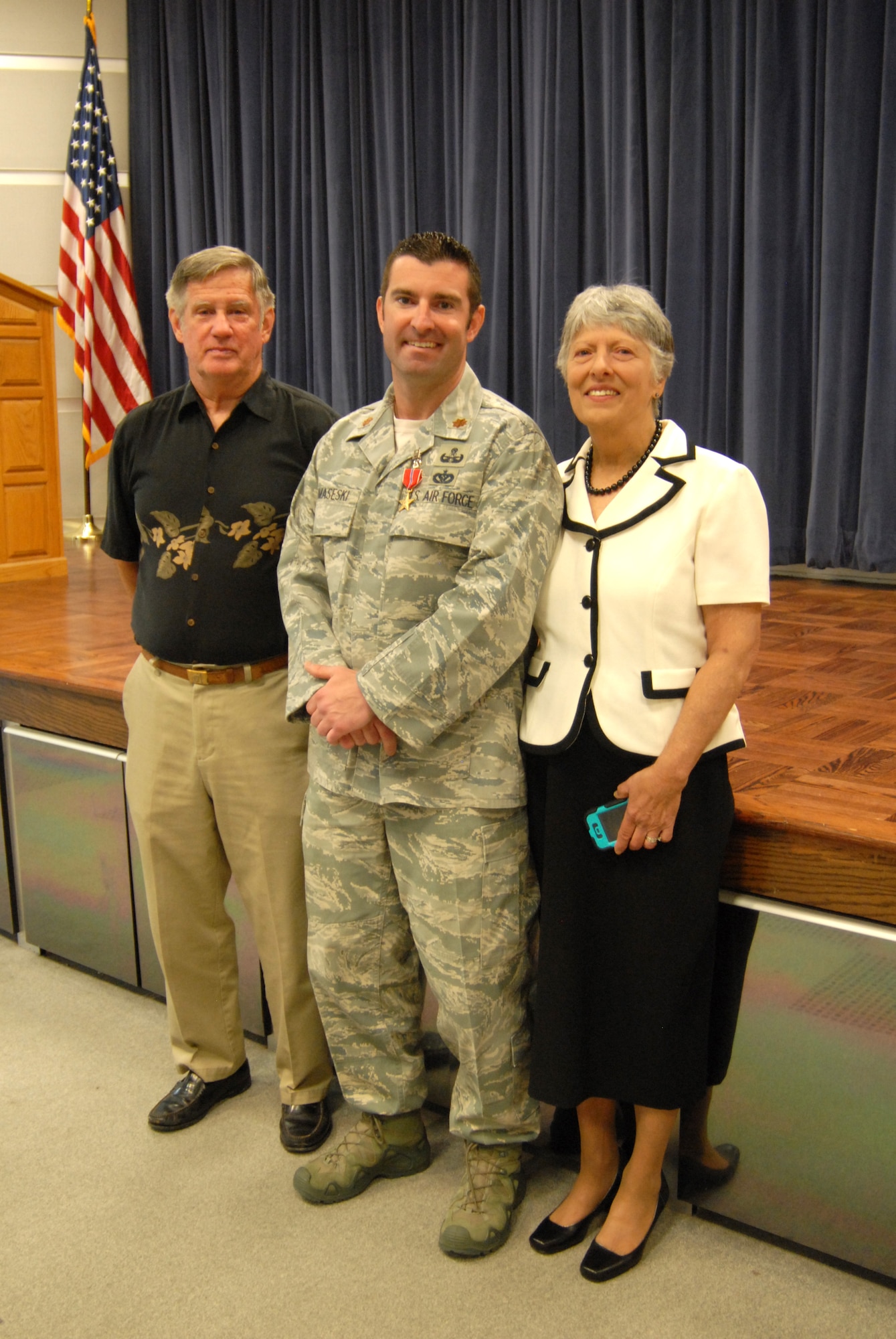 Air Force Maj. Devin Tomaseski, base civil engineer, 166th Civil Engineer Squadron, 166th Airlift Wing, Delaware ANG, with his parents, William and Cathy Tomaseski, after Maj. Tomaseski received the Bronze Star medal at a ceremony held at 166th AW HQ, New Castle ANG Base, New Castle, Del. on June 20, 2014. Tomaseski distinguished himself by exceptionally meritorious service while deployed in support of Operation Enduring Freedom in Afghanistan from 2011 to 2012. This is the third Bronze Star medal awarded to Tomaseski. (U.S. Air National Guard photo by Tech. Sgt. Benjamin Matwey)