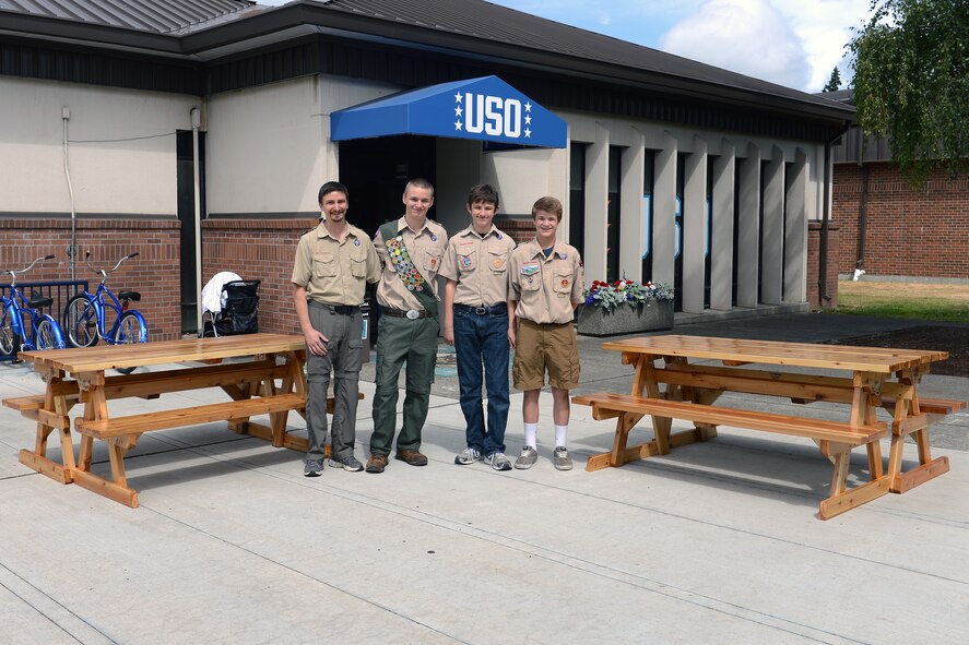 John Liechty (left), Boy Scouts Troop 647 scoutmaster, and his troop complete the assembly of two picnic tables they are donating to the USO Shali Center June 20, 2014, at Joint Base Lewis-McChord, Wash. The building of the two tables was Liechty’s son, Skyler’s community service project to earn Eagle Scout. (U.S. Air Force photo/Airman 1st Class Jacob Jimenez)      
