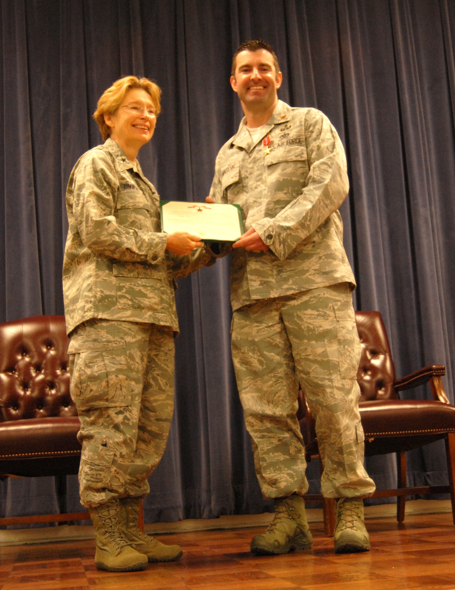 Air Force Brig. Gen. Carol Timmons, assistant adjutant general for air, Delaware National Guard, with Air Force Maj. Devin Tomaseski, base civil engineer, 166th Civil Engineer Squadron, 166th Airlift Wing, Delaware Air National Guard, after Tomaseski received the Bronze Star medal at a ceremony held at 166th AW HQ, New Castle ANG Base, New Castle, Del. on June 20, 2014. Tomaseski distinguished himself by exceptionally meritorious service while deployed in support of Operation Enduring Freedom in Afghanistan from 2011 to 2012. This is the third Bronze Star medal awarded to Tomaseski.  (U.S. Air National Guard photo by Tech. Sgt. Benjamin Matwey)
