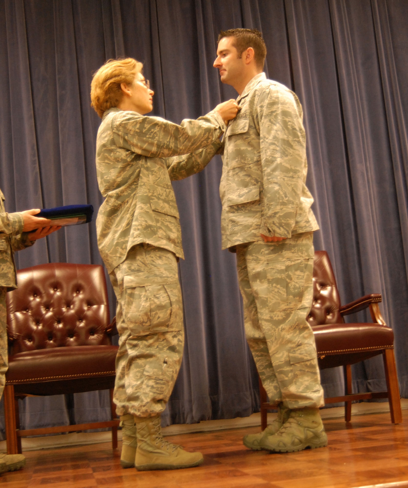Air Force Brig. Gen. Carol Timmons, assistant adjutant general for air, Delaware National Guard, pins the Bronze Star medal on Air Force Maj. Devin Tomaseski, base civil engineer, 166th Civil Engineer Squadron, 166th Airlift Wing, Delaware Air National Guard, at a ceremony held at 166th AW HQ, New Castle ANG Base, New Castle, Del. on June 20, 2014. Tomaseski distinguished himself by exceptionally meritorious service while deployed in support of Operation Enduring Freedom in Afghanistan from 2011 to 2012. This is the third Bronze Star medal awarded to Tomaseski.  (U.S. Air National Guard photo by Tech. Sgt. Benjamin Matwey)
