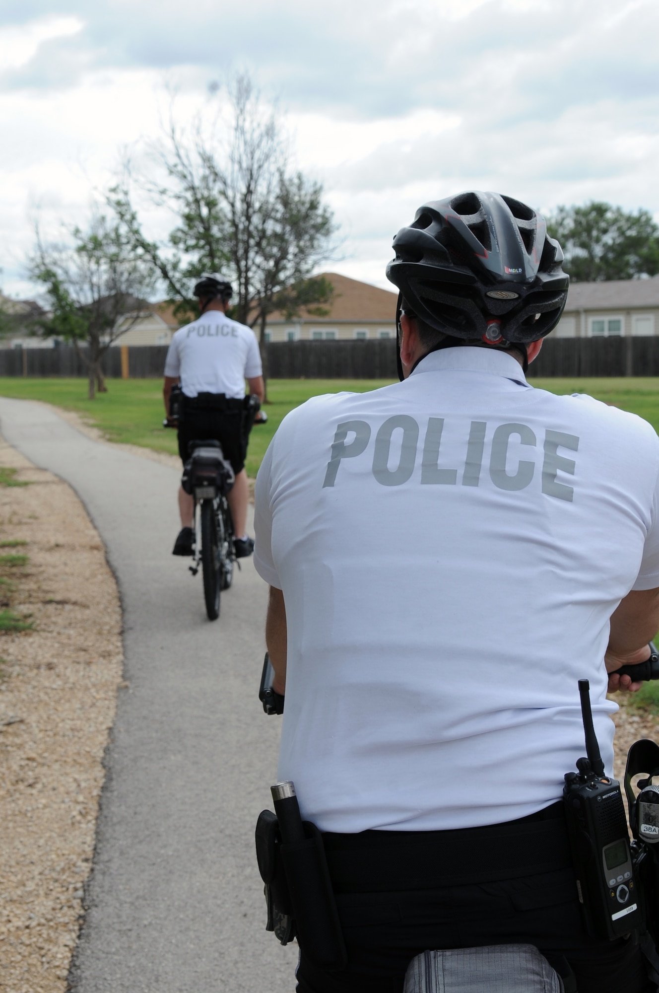 U.S. Air Force Airman 1st Class Paul Neese, front, and Senior Airman Enrique Martinez, 7th Security Forces Squadron, ride bicycles through base housing June 9, 2014, at Dyess Air Force Base, Texas. The 7th SFS will conduct bike patrol until Labor Day. Patrols will be 24/7 with Airmen working 12-hour shifts, where they are required to spend six hours on a bike and six hours in a patrol car. (U.S. Air Force photo by Senior Airman Shannon Hall/Released)
