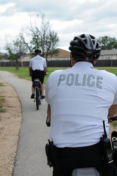 U.S. Air Force Airman 1st Class Paul Neese, front, and Senior Airman Enrique Martinez, 7th Security Forces Squadron, ride bicycles through base housing June 9, 2014, at Dyess Air Force Base, Texas. The 7th SFS will conduct bike patrol until Labor Day. Patrols will be 24/7 with Airmen working 12-hour shifts, where they are required to spend six hours on a bike and six hours in a patrol car. (U.S. Air Force photo by Senior Airman Shannon Hall/Released)