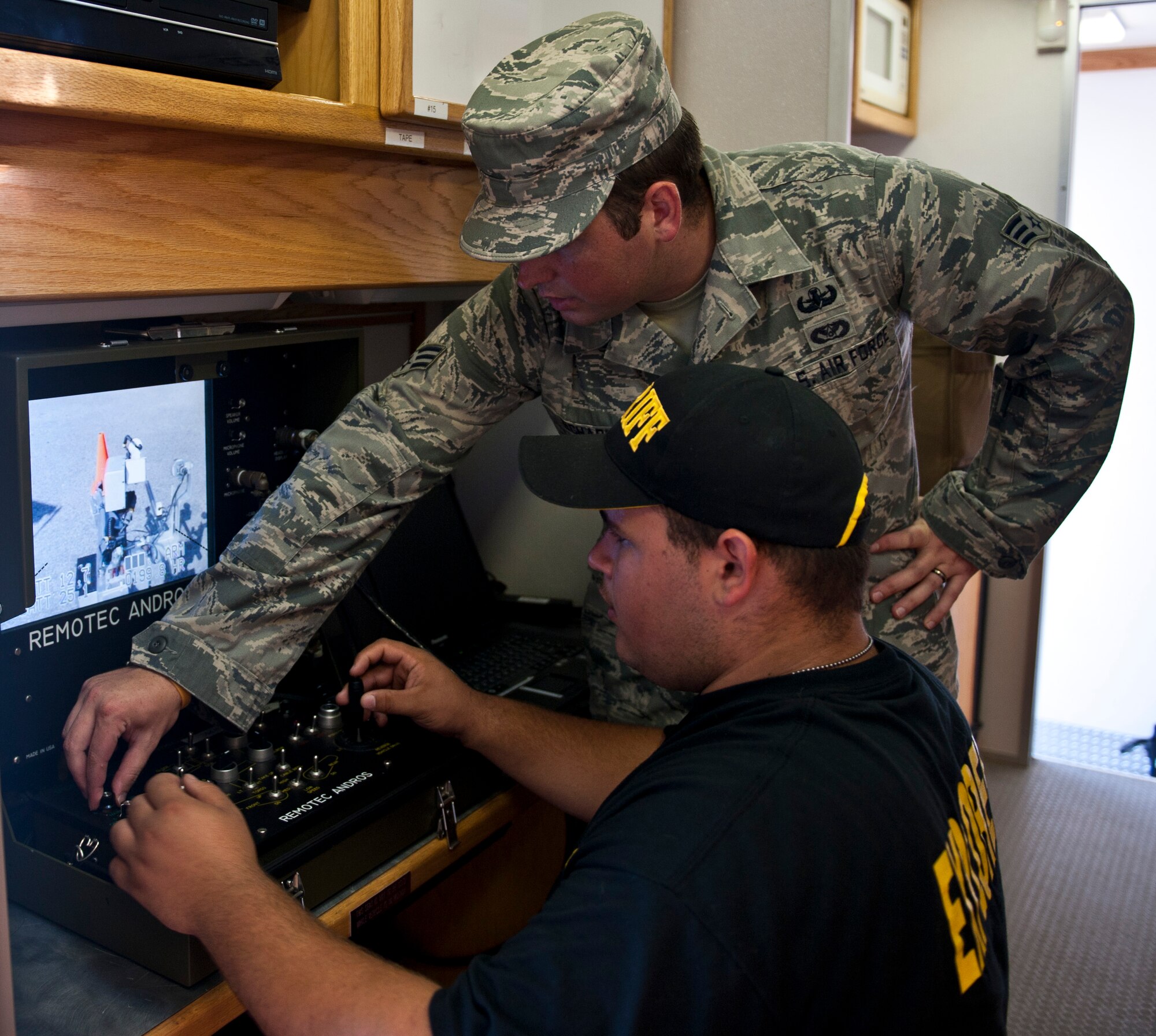 Senior Airman Eric Schabler, 1st Special Operations Civil Engineer Squadron explosive ordnance disposal journeyman, helps a student navigate the Andros F-6 robot during the Okaloosa County Sheriff’s Office youth week at the at the fairgrounds in Niceville, Fla., June 20, 2014. The event was designed to build relationships between the children of the local community and law enforcement. (U.S. Air Force photo/Senior Airman Krystal M. Garrett) 
