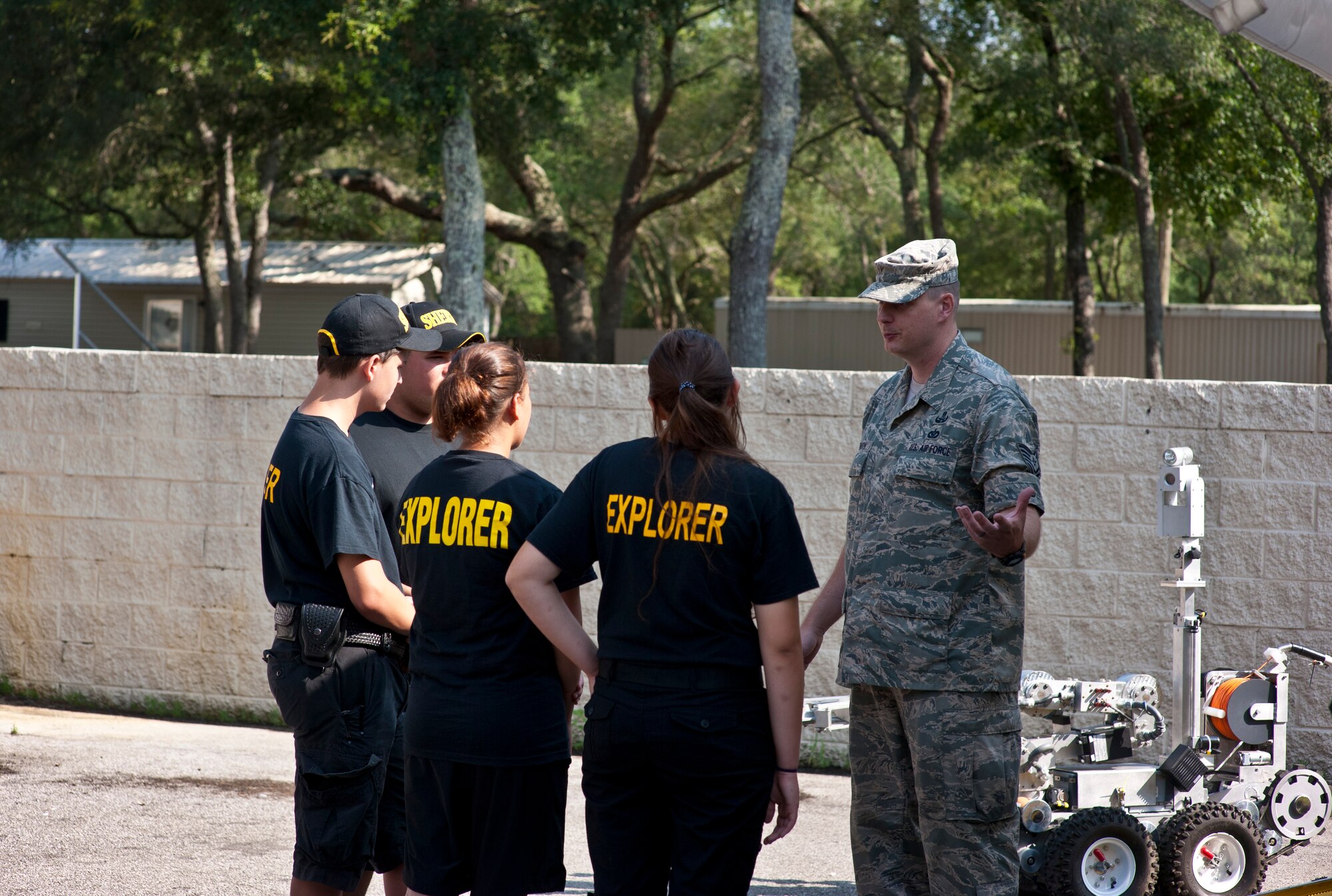 Tech. Sgt. Daniel Robinson, 1st Special Operations Civil Engineer Squadron explosive ordnance disposal section chief, explains the EOD mission to a group of students during the Okaloosa County Sheriff’s Office youth week at the fairgrounds in Niceville, Fla., June 20, 2014. The OCSO youth week was established 15 years ago. (U.S. Air Force photo/Senior Airman Krystal M. Garrett)