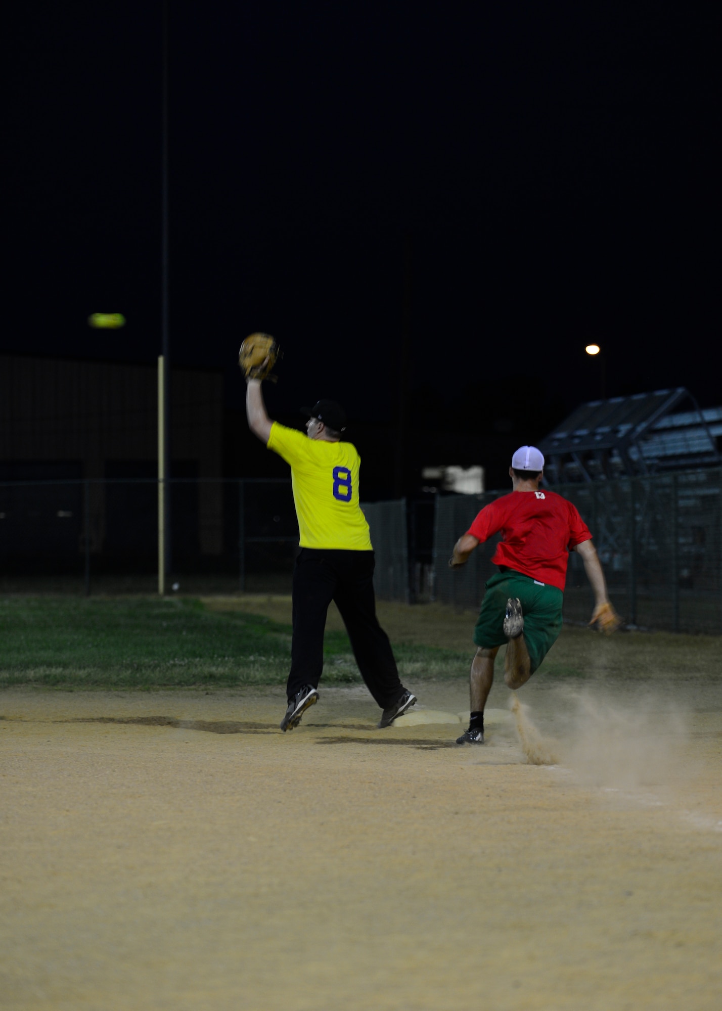 Brandon Shelton, 436th Security Forces Squadron first baseman, catches a ball to get out Zachary Parsons, 436th Aerial Port Squadron left-center fielder, during an intramural softball game June 18, 2014, at the softball field on Dover Air Force Base, Del. Parsons was 2-for-4 in the loss to the 436th SFS, 11-8. (U.S. Air Force photo/Airman 1st Class William Johnson)