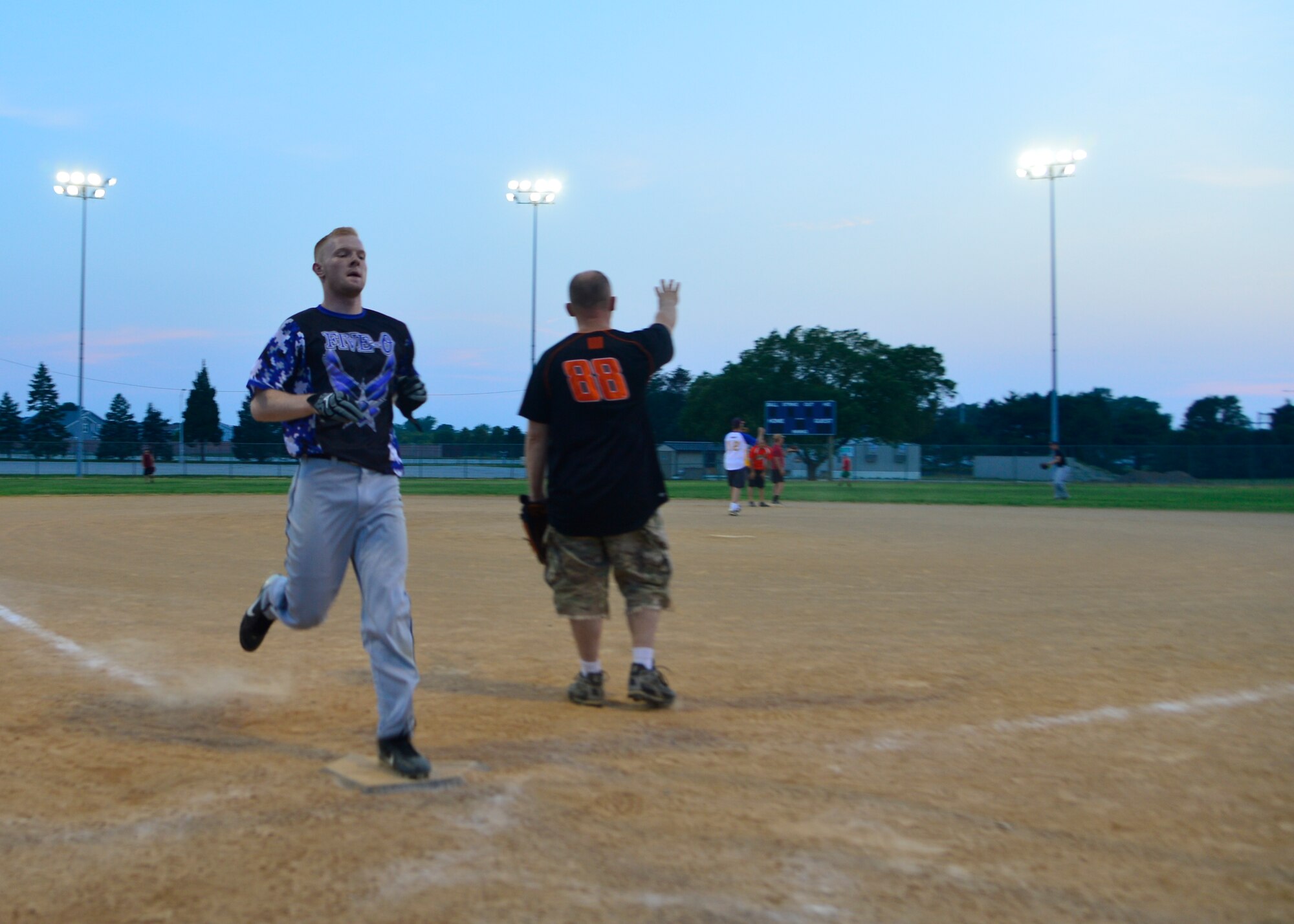 Donnie Maas, 436th Security Forces Squadron left fielder, sprints in for a run against the 436th Aerial Port Squadron in an intramural softball game June 18, 2014, at the softball field on Dover Air Force Base, Del. Maas went 5-for-5 and had two RBIs for the 436th SFS win over the 436th APS, 11-8. (U.S. Air Force photo/Airman 1st Class William Johnson)