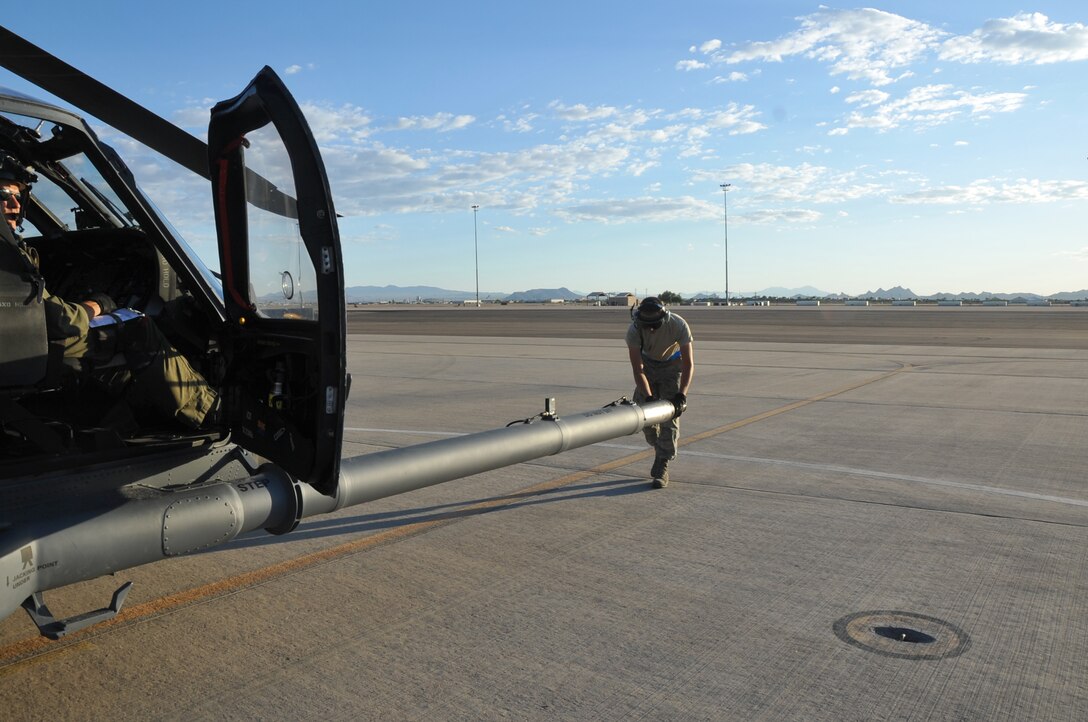 Airman 1st Class Michael Kramer, an HH-60G Pave Hawk tactical aircraft maintainer with the 943rd Rescue Group, Davis-Monthan Air Force Base, Ariz., checks the aircraft's retractable in-flight refueling probe prior to an air refueling exercise June 19, 2014. A Pave Hawk helicopter can be equipped with internal auxiliary fuel tanks, two crew-served 7.62mm or .50 caliber machine guns as well as an 8,000-pound capacity cargo hook. (U.S. Air Force photo/Senior Airman Natasha Dowridge)