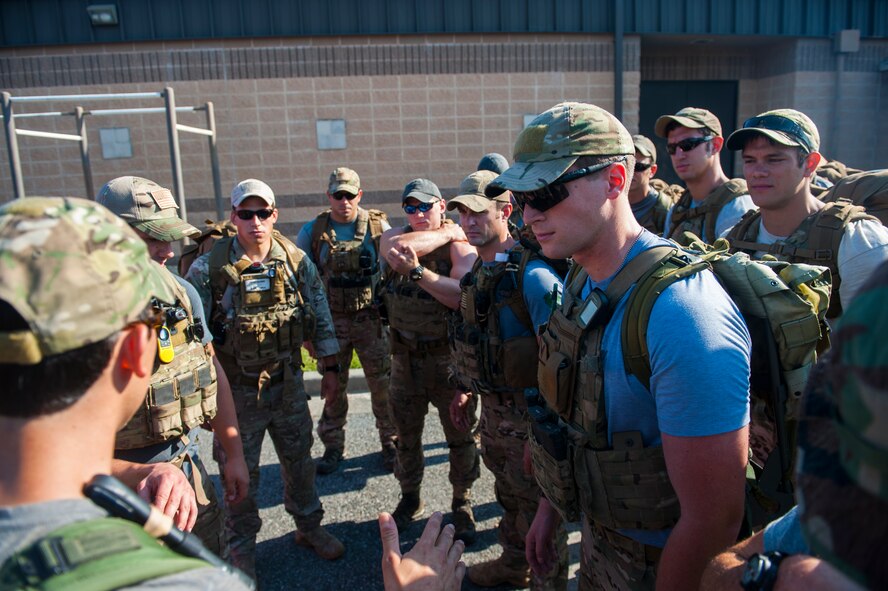 Pararescuemen from the 38th Rescue Squadron, brief one another on the task assigned to the cadets before  a ruck march at Moody Air Force Base, Ga., June 17, 2014.During the ruck march, the pararescuemen forced the cadets to perform various exercises. (U.S. Air Force photo by Airman 1st Class Ceaira Tinsley/Released)