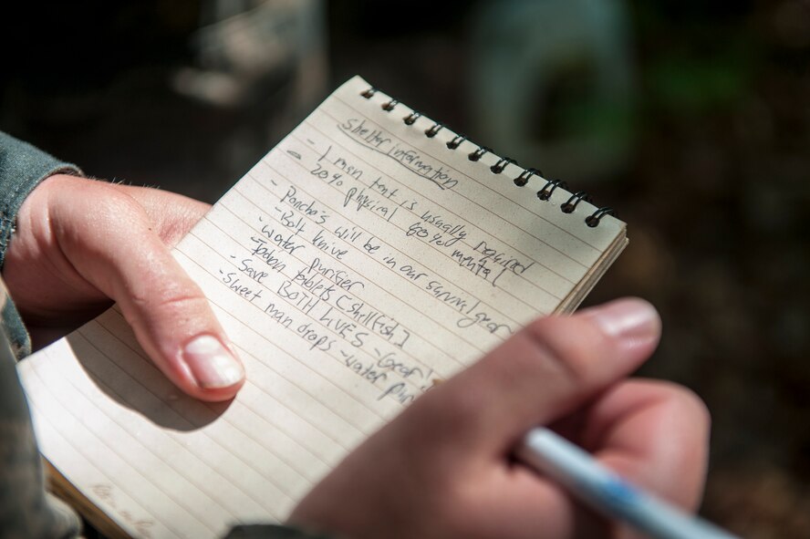 U.S. Air Force cadet , takes notes during a Survival, Evasion, Resistance and Escape training class at Moody Air Force Base, Ga., June 17, 2014. The SERE class taught the cadets basic survival skills such as building shelter and tying basic knots. (U.S. Air Force photo by Airman 1st Class Ceaira Tinsley/Released)