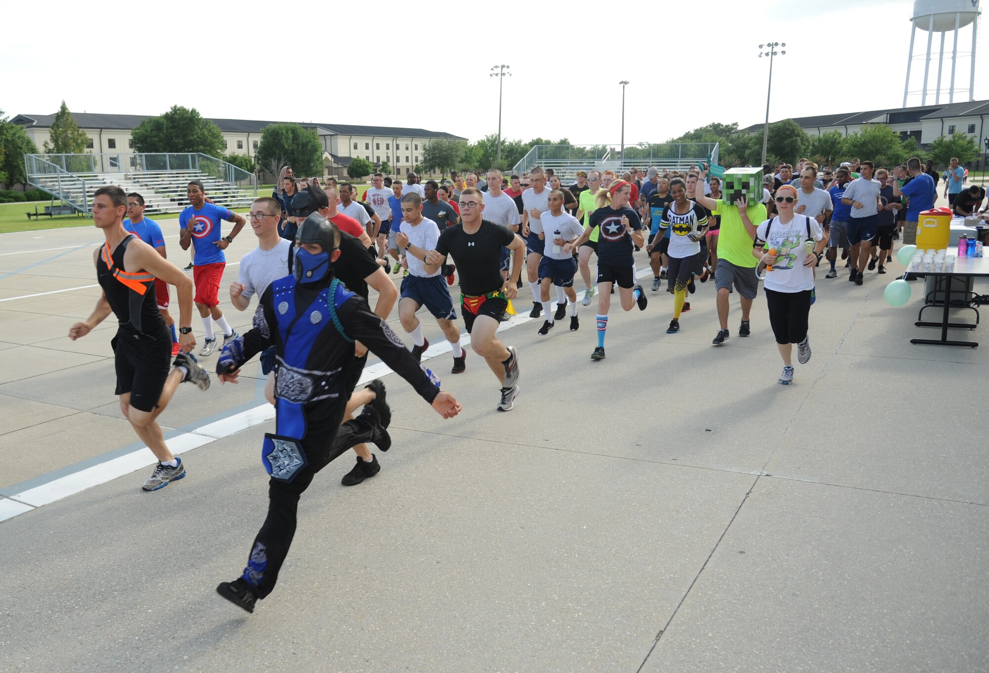 Keesler personnel participate in a 5K run hosted by the 81st Training Group teal rope program June 19, 2014, at the Triangle, Keesler Air Force Base, Miss.  The super hero themed event raised more than $1,300 for the Gulf Coast Women’s Shelter for Non-Violence.   (U.S. Air Force photo by Kemberly Groue)