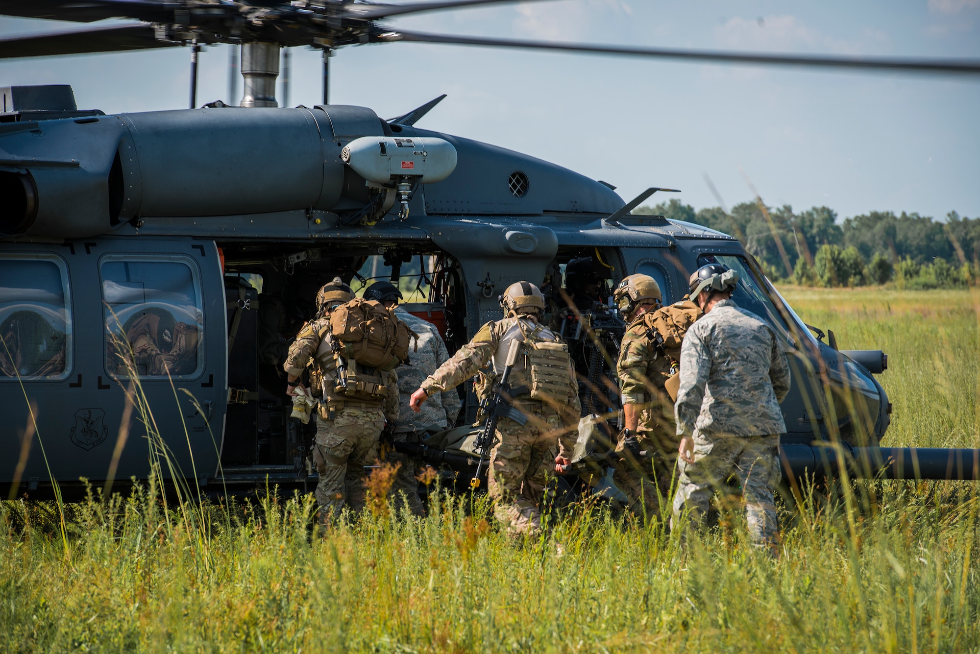 U.S. Air Force cadets and pararescuemen from the 38th Rescue Squadron transport a patient to an HH-60G Pave Hawk during a combat search and rescue demonstration at Moody Air Force Base, Ga., June 18, 2014. The demonstration emulated a medical evacuation for troops injured in a convoy ambush with opposing forces in the area. (U.S. Air Force photo by Airman 1st Class Ryan Callaghan/Released)
