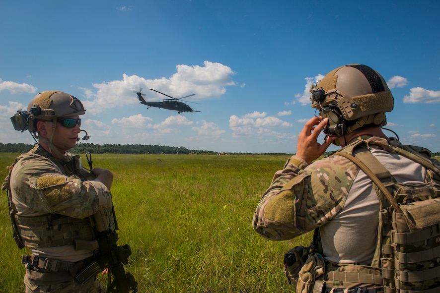 Pararescuemen from the 38th Rescue Squadron communicate with an HH-60G Pave Hawk at Moody Air Force Base, Ga., June 18, 2014. The demonstration exposed U.S. Air Force Reserve Officers' Training Corps cadets to the operational responsibilities of a combat rescue officer as a part of the combat rescue officer shadow and orientation week. (U.S. Air Force photo by Airman 1st Class Ryan Callaghan/Released)
