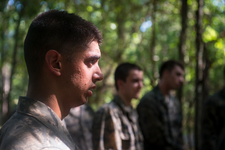 U.S. Air Force Cadet Daniel Fresella observes a survival, evasion, resistance and escape (SERE) demonstration at Moody Air Force Base, Ga., June 17, 2014. During the combat rescue officer (CRO) shadow and orientation week, cadets got hands-on experience in SERE, water survival, parachuting and night operations. (U.S. Air Force photo by Airman 1st Class Ryan Callaghan/Released)
