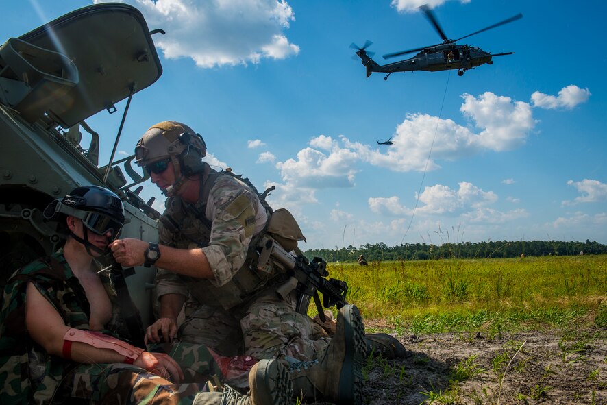 U.S. Air Force Cadet Ryan Sypher is treated by a pararescueman from the 38th Rescue Squadron during a combat search and rescue demonstration at Moody Air Force Base, Ga., June 18, 2014.  The demonstration, which  put cadets directly in the action onboard HH-60G Pave Hawks, was a part of the combat rescue officer shadow and orientation week. (U.S. Air Force photo by Airman 1st Class Ryan Callaghan/Released)
