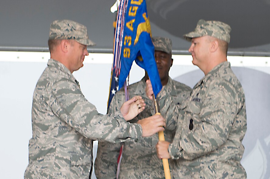 U.S. Air Force Col. Mike Ross (right) assumes command of the 820th Base Defense Group as he receives the unit guidon from Col. Samuel Milam, 93d Air and Ground Operations Wing commander,  during a change of command ceremony at Moody Air Force Base, Ga., June 20, 2014. Before coming to Moody, Ross served as the U.S. Air Forces Central Command director of force protection at Al Udeid Air Base, Qatar. (U.S. Air Force photo by Airman Dillian Bamman/Released)