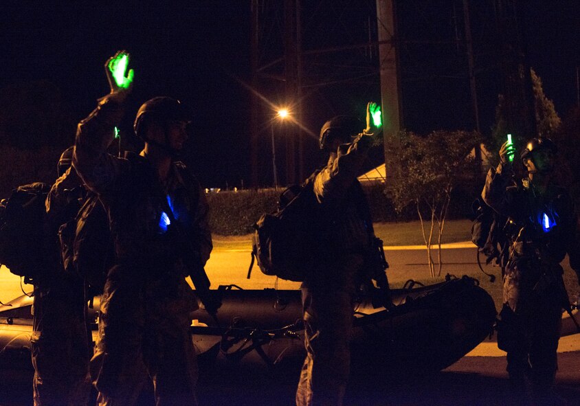 U.S. Air Force Cadets take an accountability break after carrying an 38th Rescue Squadron rescue boat during the combat rescue officer shadow and orientation week at Moody Air Force Base, Ga., June 19, 2014. The 38th RQS challenged cadets with carrying two boats more than two miles during their field training water exercise. (U.S. Air Force photo by Airman Dillian Bamman/Released)